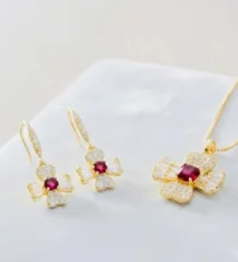 Red gold pendant set with a gold color flower motif necklace and hook earrings for artificial jewellery online shopping in Lahore.