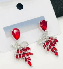multi color drop earrings with a bow motif and dangling red crystals for artificial jewellery online shopping in Lahore.