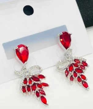 multi color drop earrings with a bow motif and dangling red crystals for artificial jewellery online shopping in Lahore.